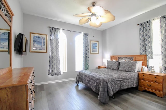 bedroom with dark wood-type flooring and ceiling fan