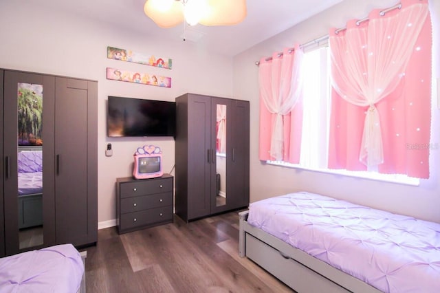 bedroom with dark wood-type flooring