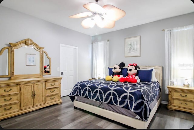 bedroom with dark hardwood / wood-style flooring