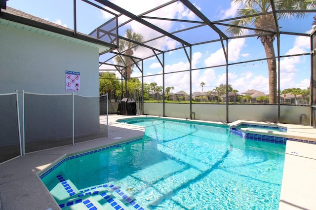 view of pool featuring an in ground hot tub, a lanai, and a patio