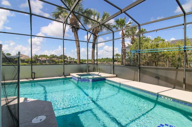 view of swimming pool featuring an in ground hot tub, a lanai, and a patio