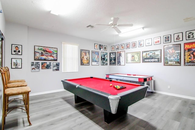 recreation room with ceiling fan, billiards, hardwood / wood-style floors, and a textured ceiling