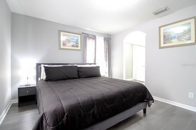 bedroom featuring dark hardwood / wood-style flooring and a closet