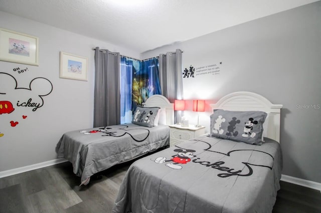 bedroom with dark wood-type flooring