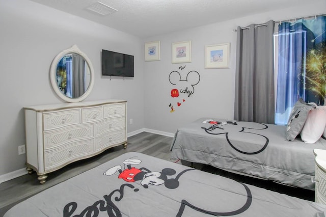 bedroom with hardwood / wood-style floors