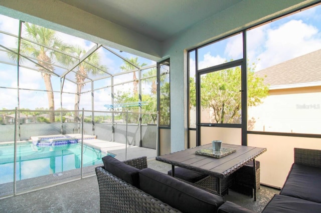 view of pool with a lanai, a patio area, and an in ground hot tub