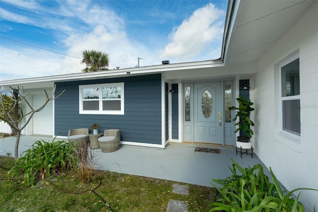 view of exterior entry with a garage