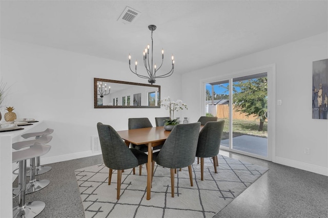 dining area with an inviting chandelier