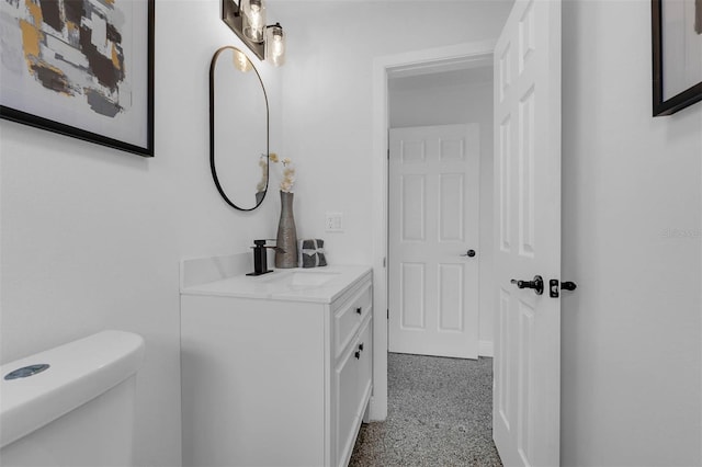 bathroom featuring vanity and toilet