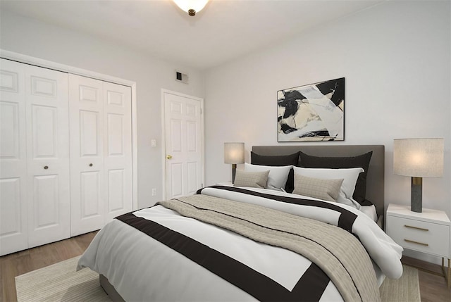 bedroom featuring wood-type flooring and a closet