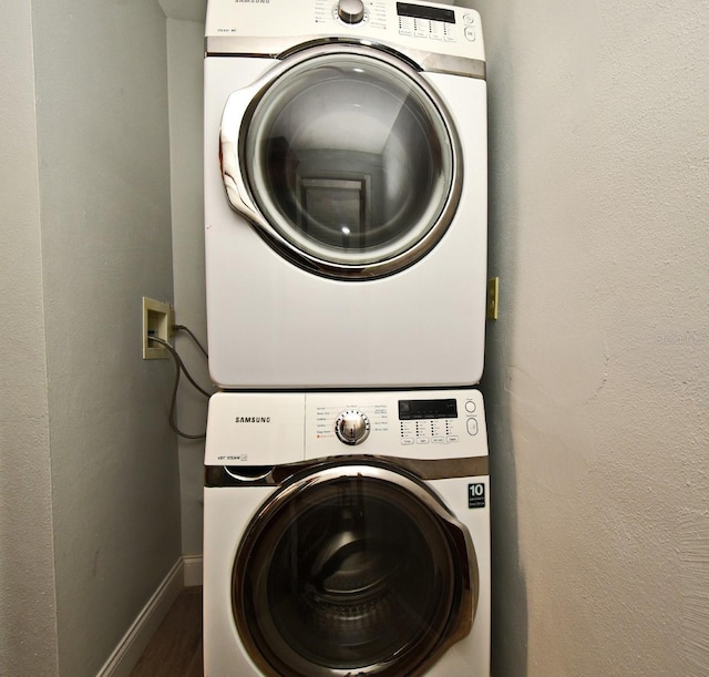 washroom featuring stacked washer / dryer