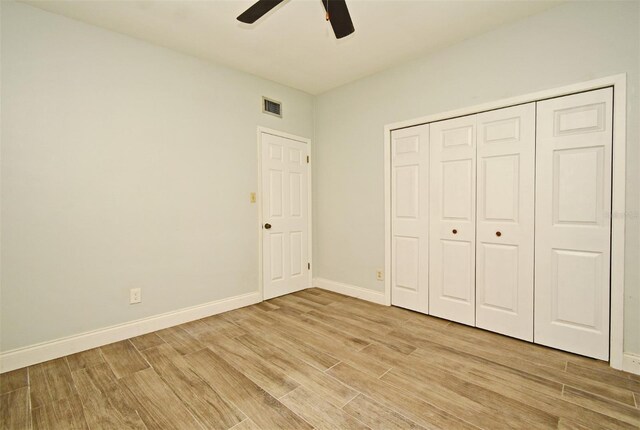 unfurnished bedroom featuring a closet, ceiling fan, and light hardwood / wood-style flooring