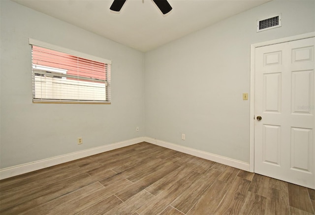 spare room with wood-type flooring and ceiling fan