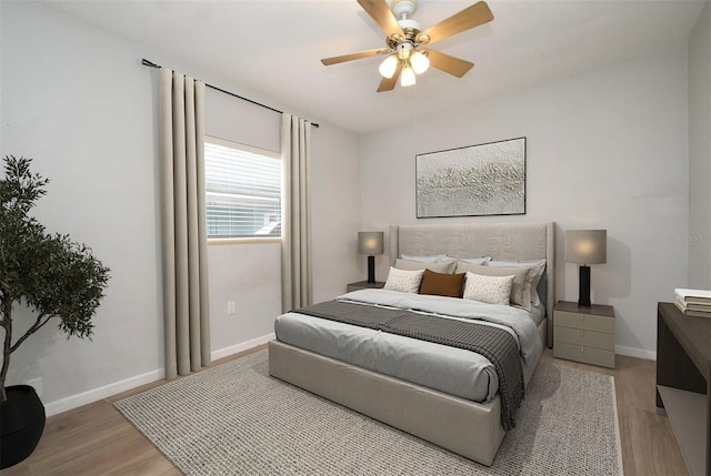 bedroom with ceiling fan and light wood-type flooring