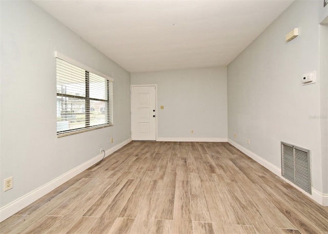 spare room featuring light hardwood / wood-style floors