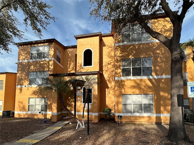 rear view of house with central air condition unit