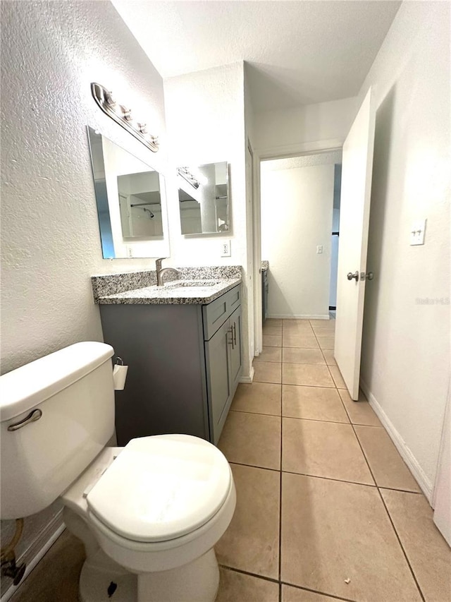 bathroom with vanity, toilet, and tile patterned flooring