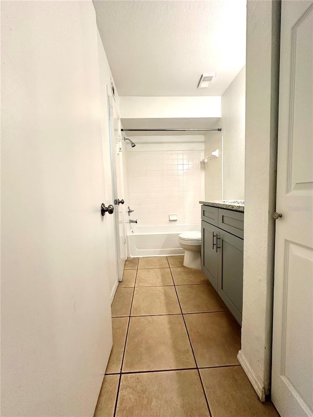 full bathroom with tile patterned floors, vanity, toilet, and tiled shower / bath