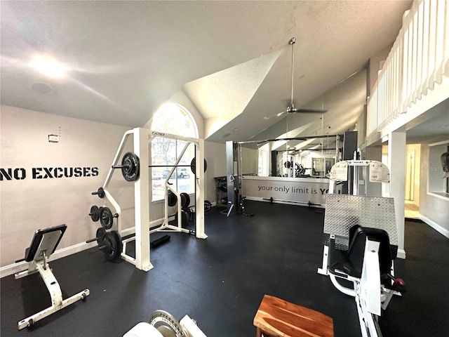 exercise room featuring vaulted ceiling and a textured ceiling