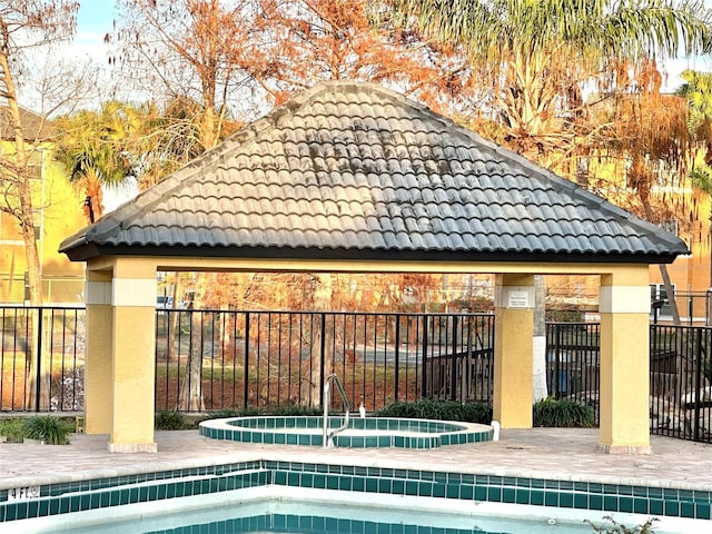 exterior space featuring a gazebo and a hot tub