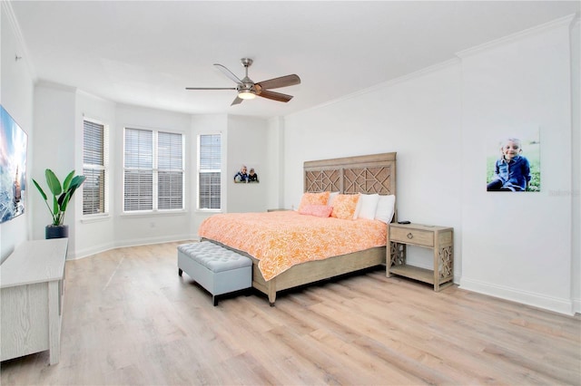 bedroom with ornamental molding, ceiling fan, and light hardwood / wood-style floors