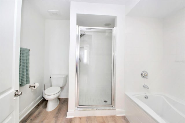 bathroom with shower with separate bathtub, hardwood / wood-style floors, and toilet