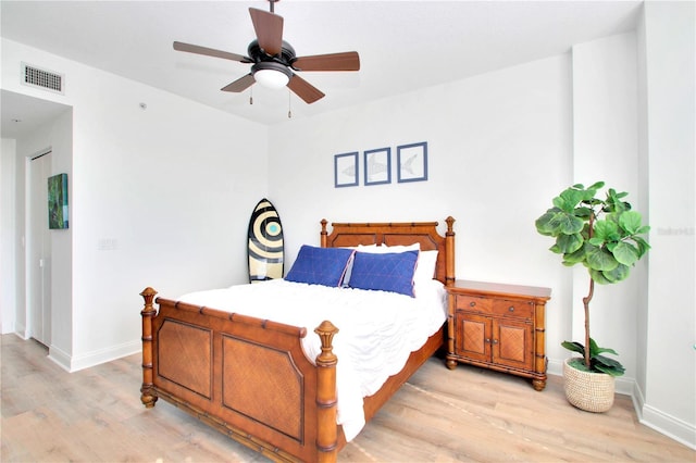 bedroom with ceiling fan and light hardwood / wood-style floors