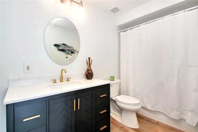 bathroom with vanity, wood-type flooring, and toilet