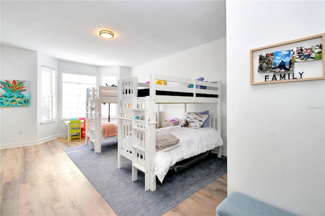 bedroom featuring wood-type flooring and a textured ceiling