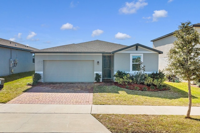 ranch-style home with a garage and a front lawn