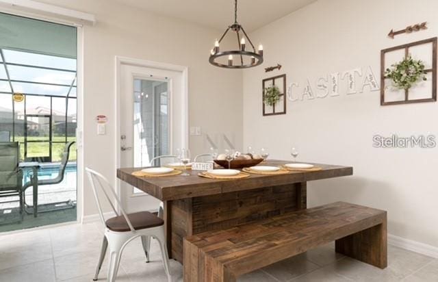 dining area with light tile patterned floors and a notable chandelier