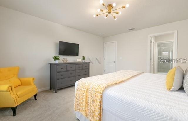 carpeted bedroom with an inviting chandelier