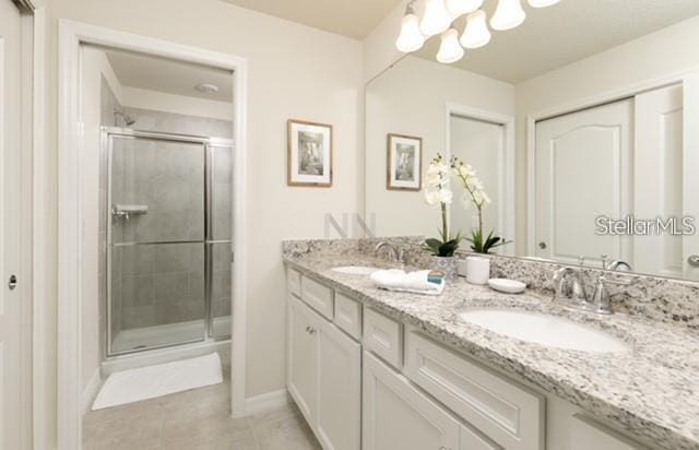 bathroom with walk in shower, tile patterned floors, and vanity