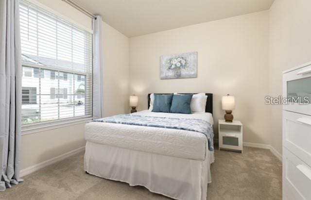 carpeted bedroom with multiple windows