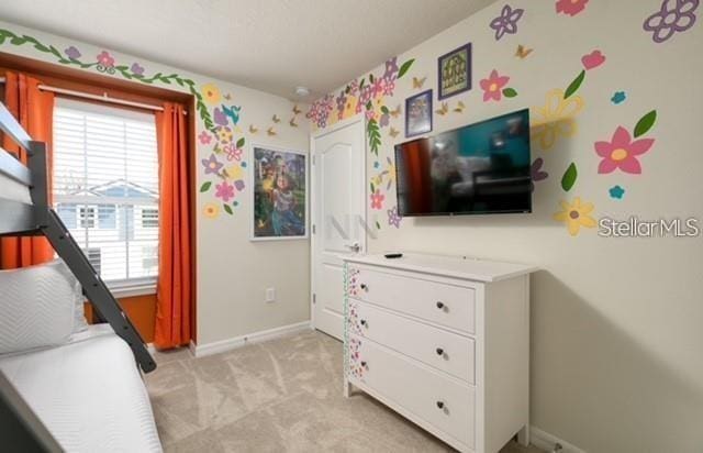 carpeted bedroom featuring multiple windows