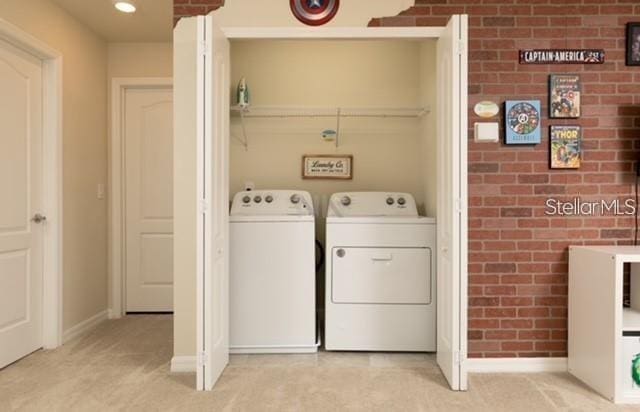 laundry room featuring separate washer and dryer and light carpet