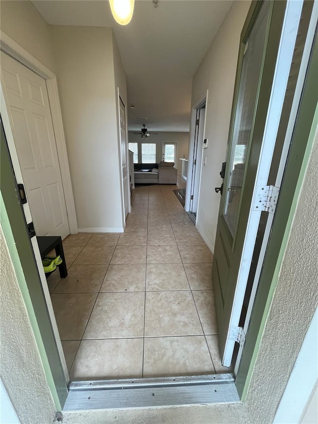 hallway featuring light tile patterned floors