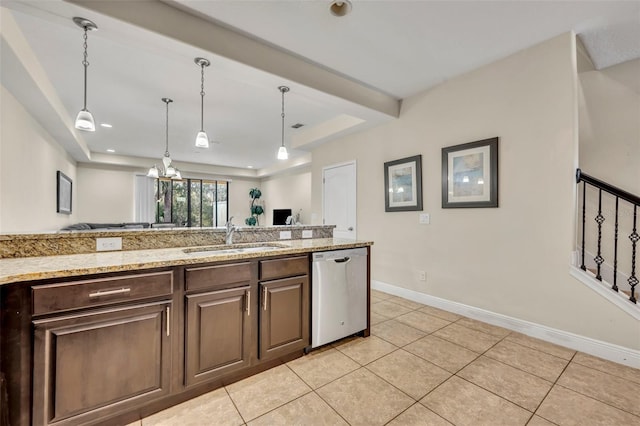 kitchen with sink, light tile patterned floors, stainless steel dishwasher, and a raised ceiling