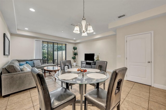 dining room with an inviting chandelier and light tile patterned floors