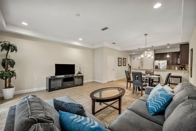 tiled living room with a tray ceiling