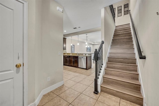 staircase featuring tile patterned flooring