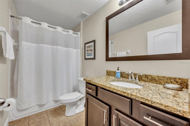 full bathroom with shower / bathtub combination with curtain, tile patterned flooring, vanity, a textured ceiling, and toilet