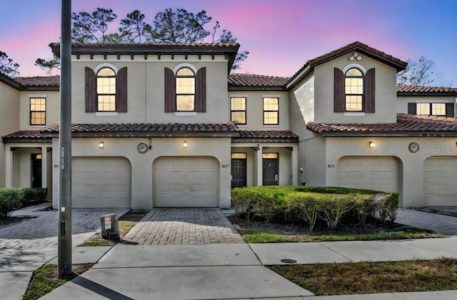 mediterranean / spanish-style home with a garage