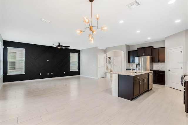 kitchen featuring appliances with stainless steel finishes, pendant lighting, sink, ceiling fan, and dark brown cabinets