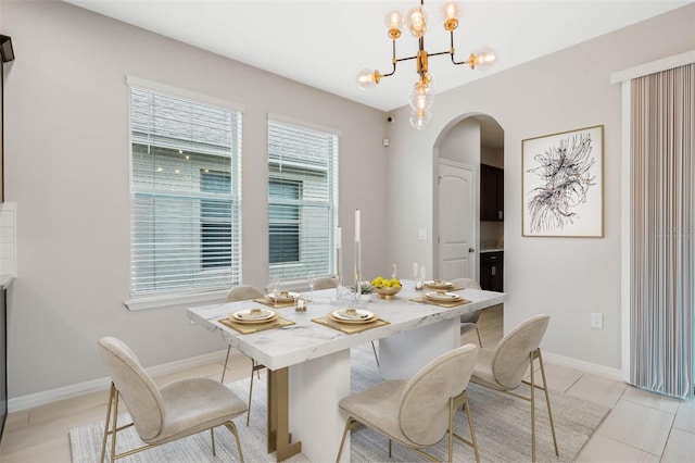 dining space with an inviting chandelier and light tile patterned floors