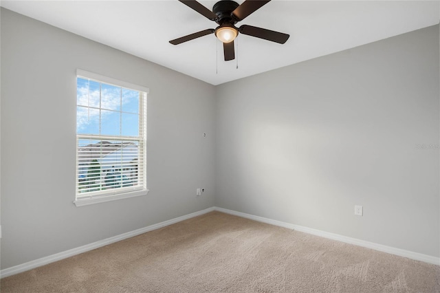 empty room featuring carpet floors and ceiling fan