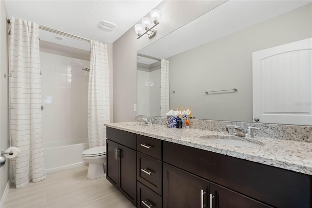 full bathroom with vanity, shower / tub combo with curtain, and toilet