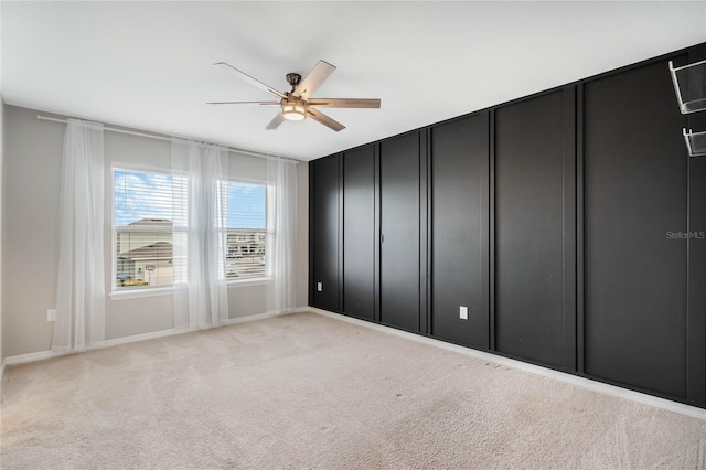 unfurnished bedroom featuring light carpet and ceiling fan