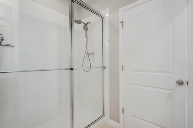 bathroom with a shower with shower door