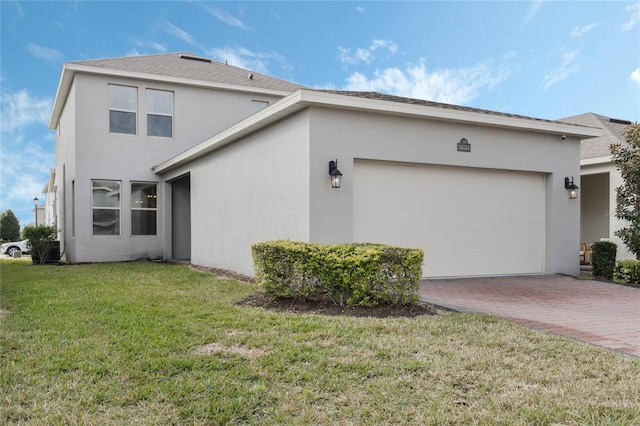 view of side of home featuring a garage and a lawn